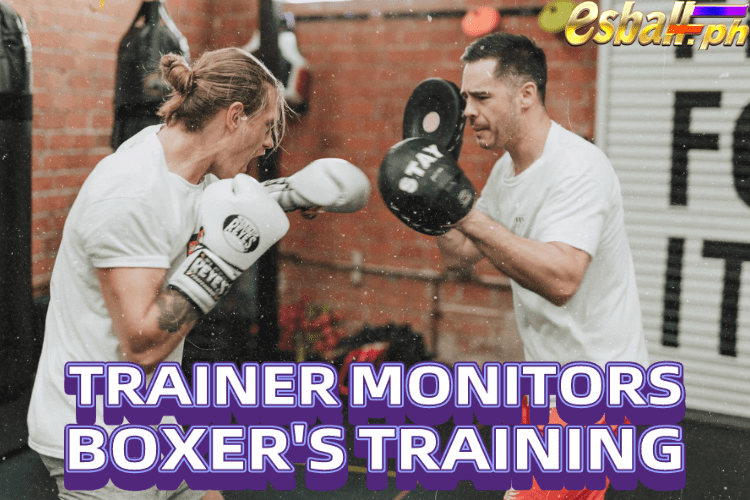 Trainer Monitors Boxer's Training